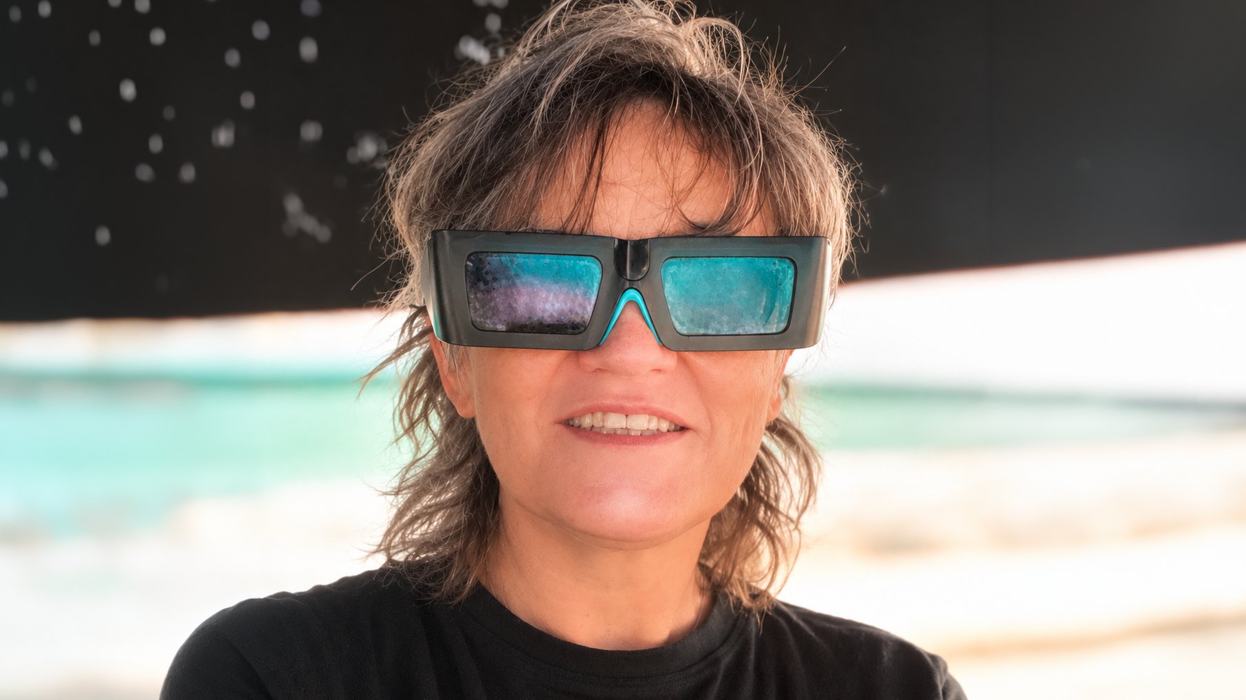 Jola Kudela wearing 3D glasses by the sea